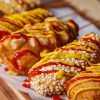 Mini hotdog and cheese bites cooking in a waffle iron, golden brown and crispy, showcasing an easy snack recipe