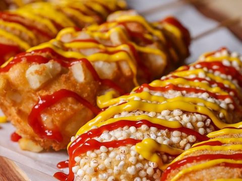 Mini hotdog and cheese bites cooking in a waffle iron, golden brown and crispy, showcasing an easy snack recipe