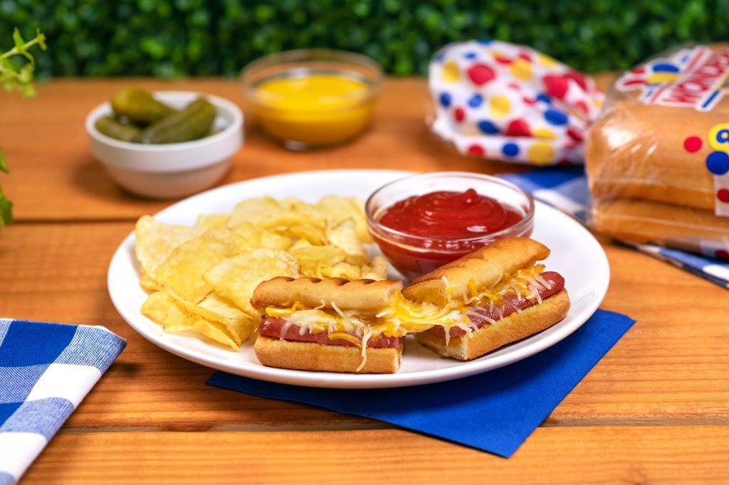 Mini hotdog and cheese snacks cooked in a waffle iron, golden and crispy with melted cheese inside, served as fun bite-sized delights