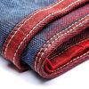 Close-up of Japanese selvedge denim fabric showcasing detailed stitching and craftsmanship