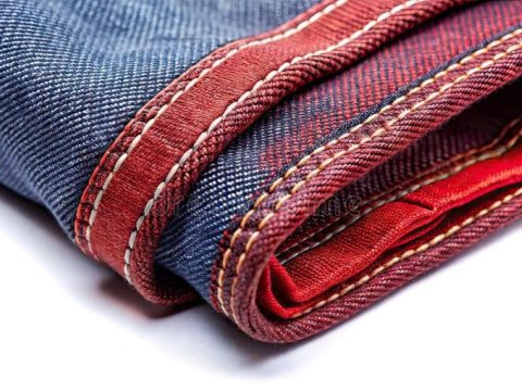 Close-up of Japanese selvedge denim fabric showcasing detailed stitching and craftsmanship
