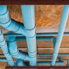 Realistic Houston home plumbing system showing pipes inside walls and ceilings with visible structure