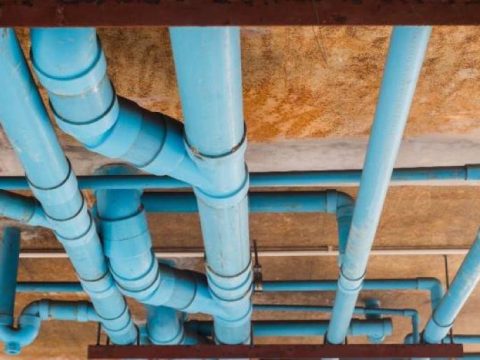Realistic Houston home plumbing system showing pipes inside walls and ceilings with visible structure