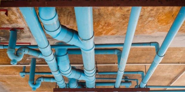 Realistic Houston home plumbing system showing pipes inside walls and ceilings with visible structure