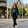 Person walking in the city wearing a compact lightweight sling bag.