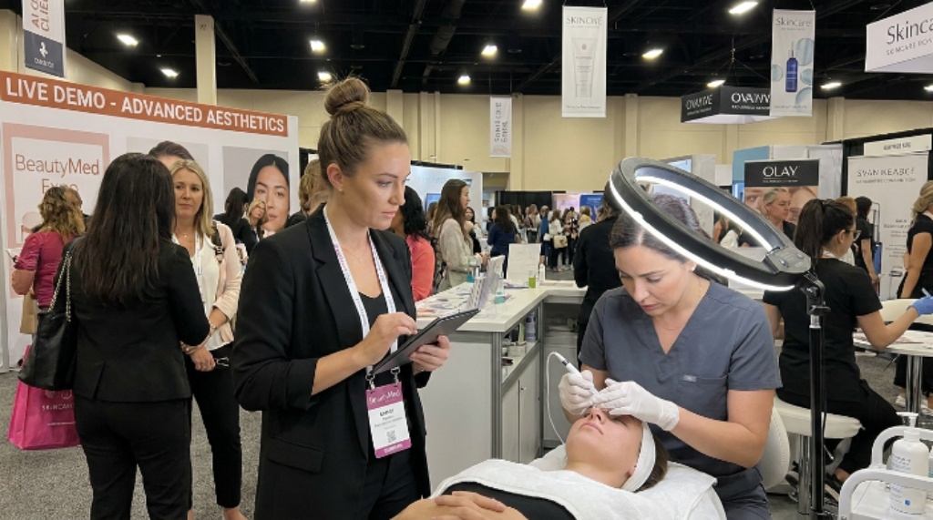 Beauty professional attending a live treatment demonstration at BeautyMed Expo