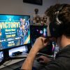 Budget gaming headset resting on a desk with a keyboard.
