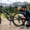 Mountain biker performing essential bike maintenance checks before a trail ride