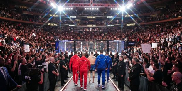UFC fighters entering the octagon at a packed Madison Square Garden in New York City during a November numbered event