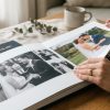 Hands turning heavy matte pages of a layflat wedding photobook.