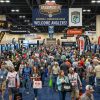 Crowds walking through the Bassmaster Classic Outdoors Expo floor surrounded by fishing gear exhibitor booths at Greenville Convention Center 2027