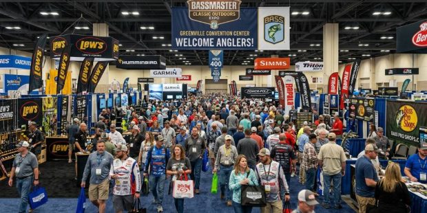 Crowds walking through the Bassmaster Classic Outdoors Expo floor surrounded by fishing gear exhibitor booths at Greenville Convention Center 2027