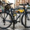 Cyclist locking a bicycle wheel with a steel cable